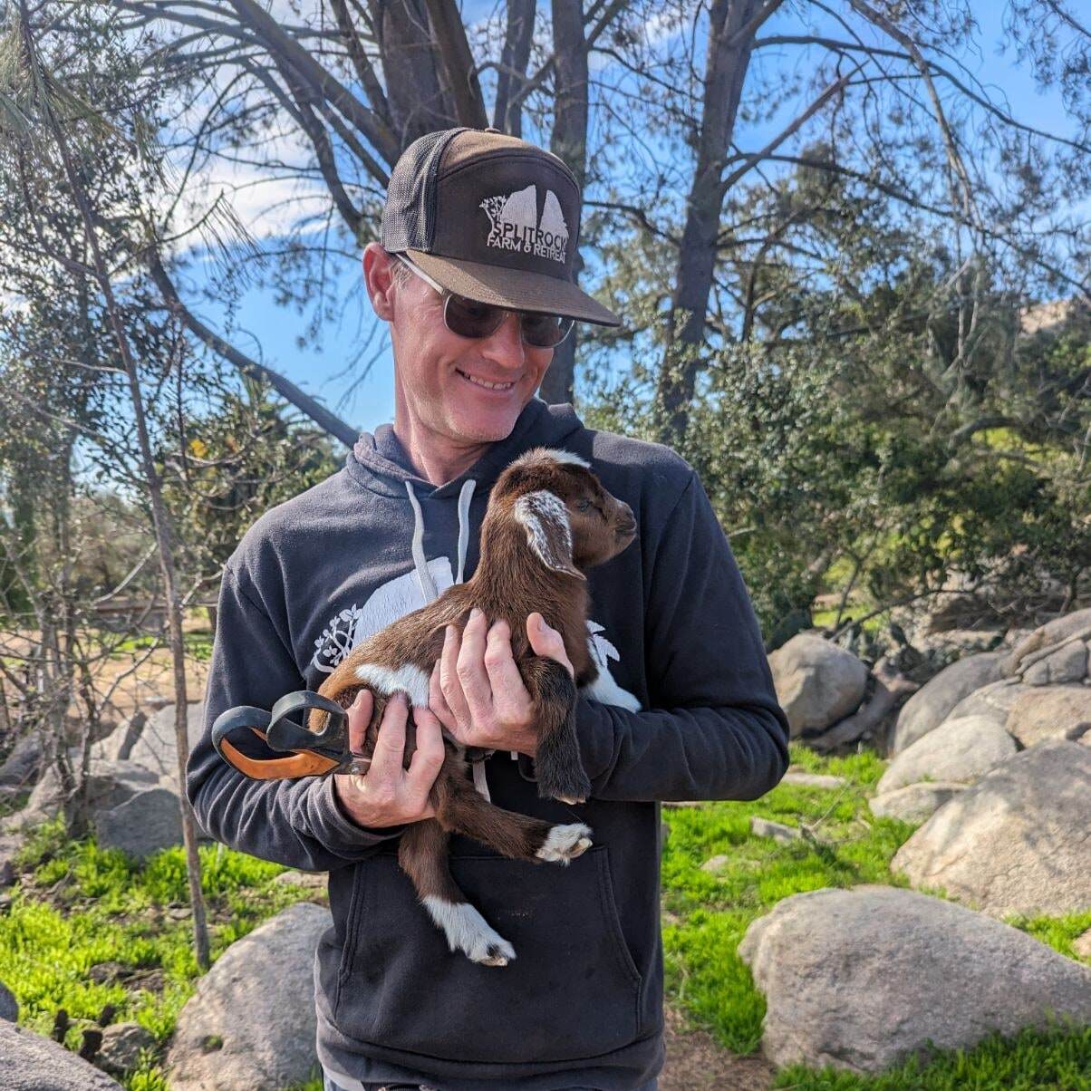 Host of Splitrock, Ben Corbett with a baby goat