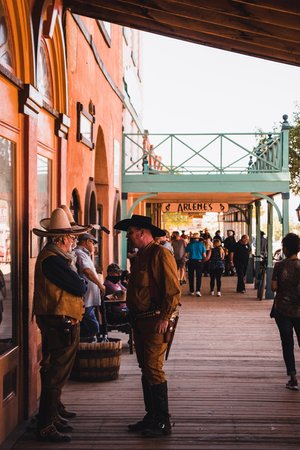 Cowboys outside of western-style buildings